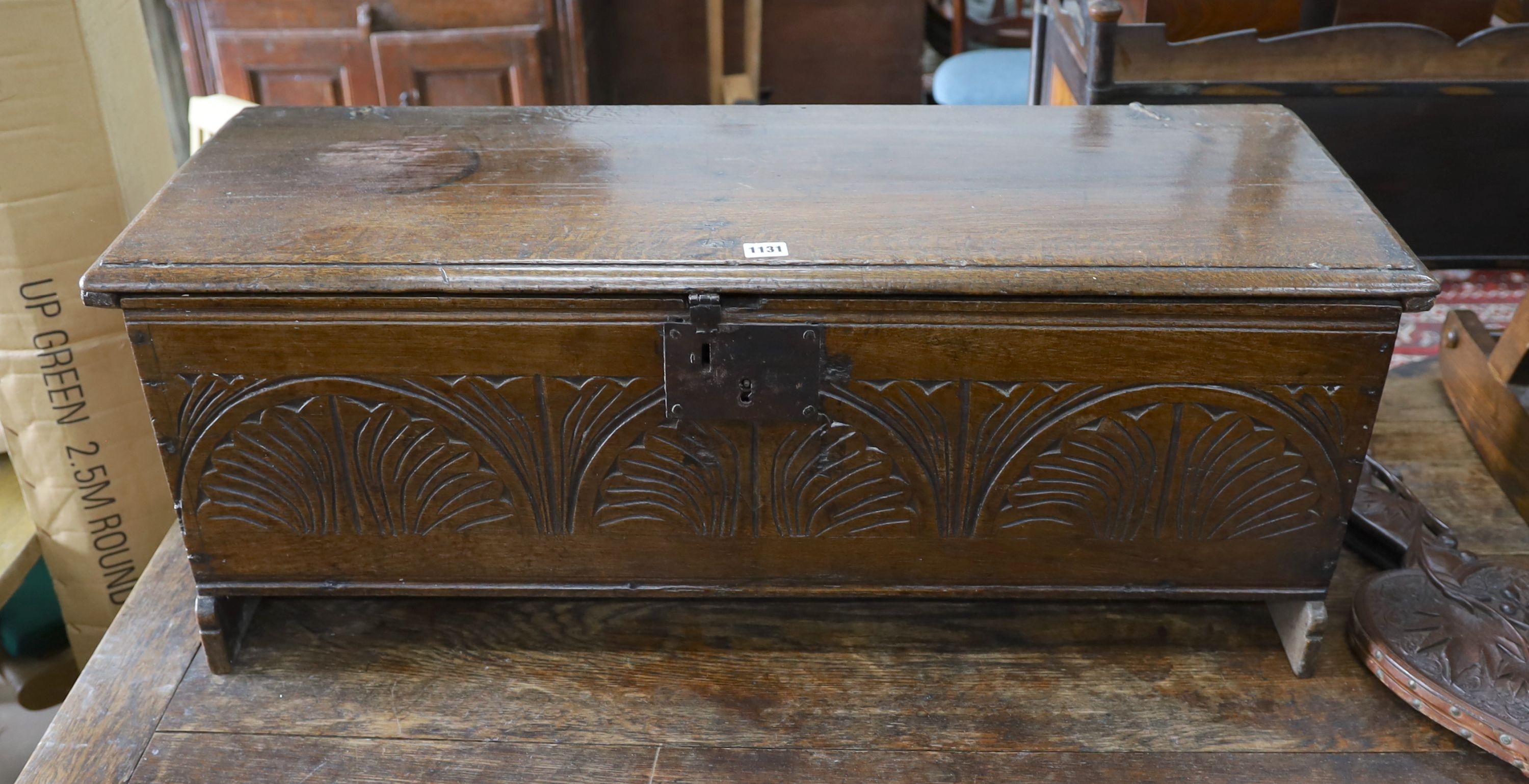 A 17th century carved oak six plank coffer, W 99, D 36, H 38cms.